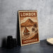 A vintage-style metal sign with a sailboat and palm trees, depicting the island of Lombok, Indonesia.