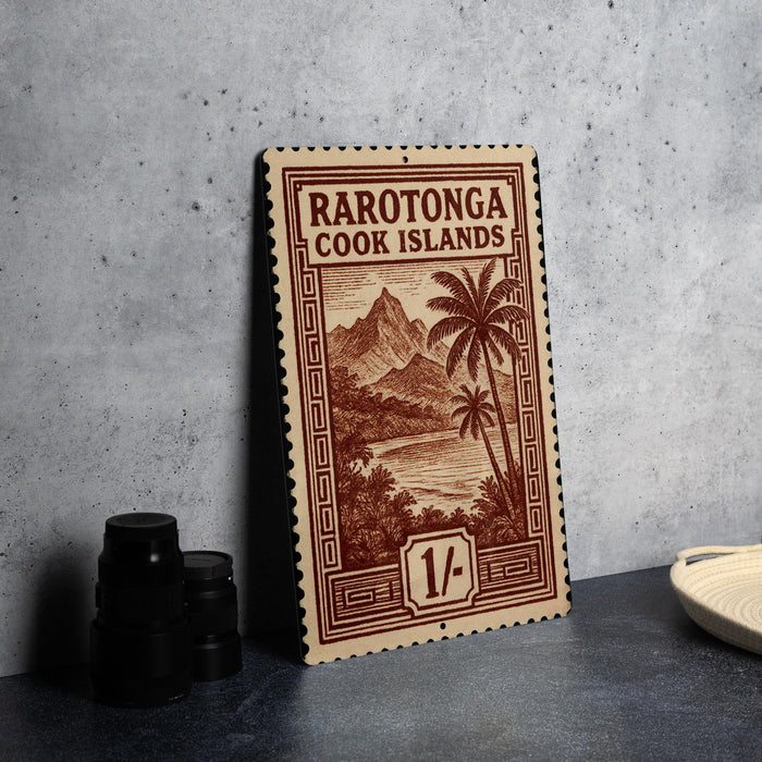 a framed print of a postage stamp from the Cook Islands, with a tropical landscape and palm trees depicted on it.