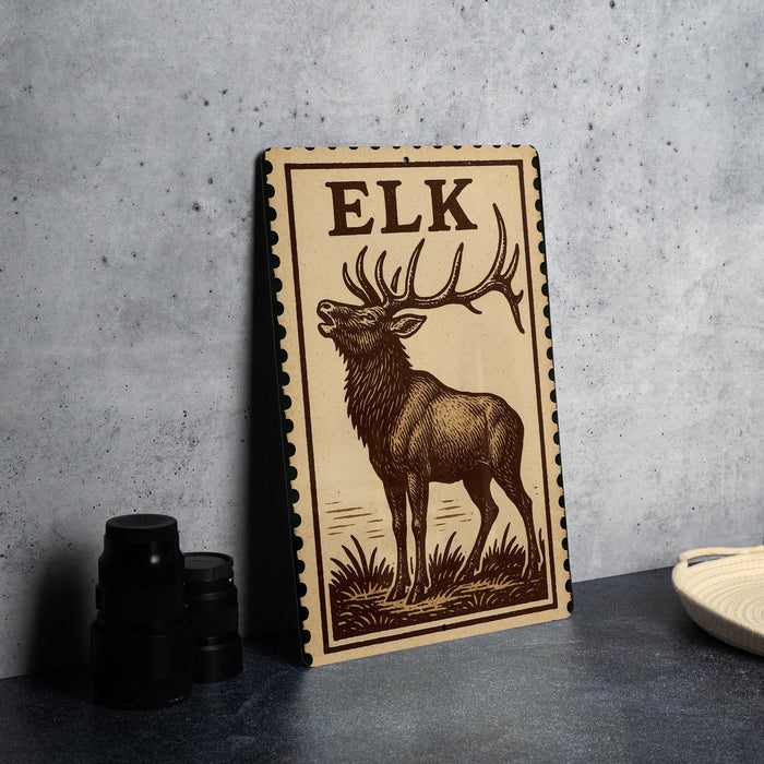 a wooden sign with a deer illustration, standing on a table next to some black camera lenses.