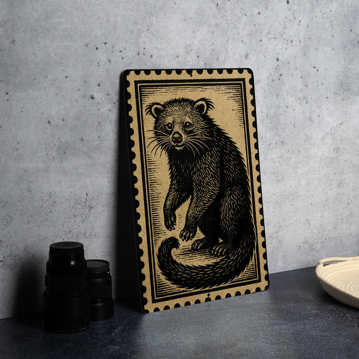 a framed illustration of a raccoon on a black and white background, placed on a table next to some black camera lenses.