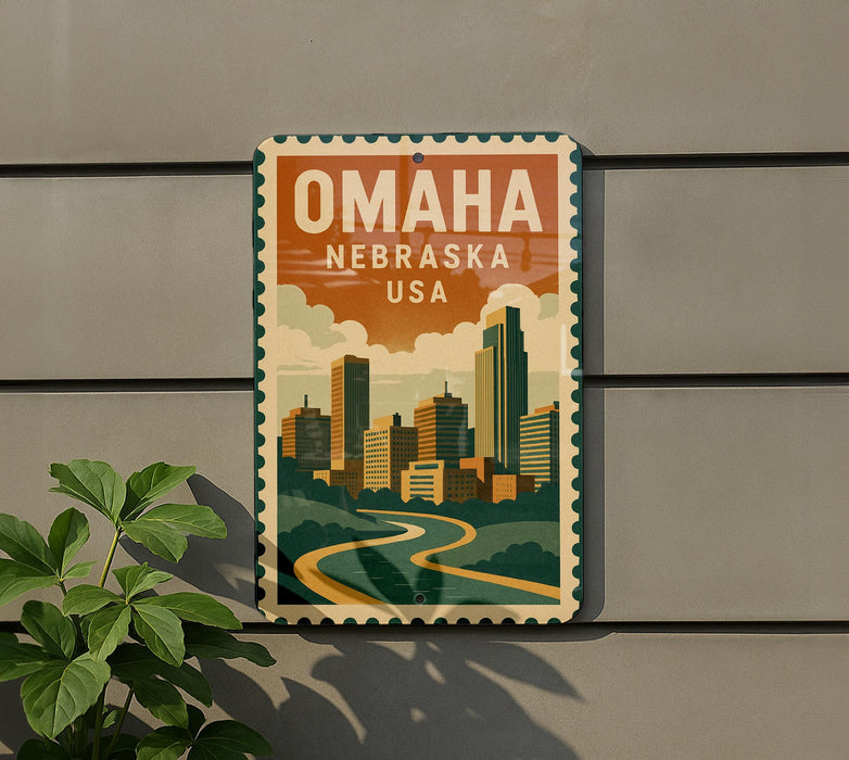 A vintage-style metal sign with the text "OMAHA NEBRASKA USA" displayed on it, featuring an illustration of a cityscape with a river and buildings.