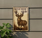 a wooden sign with a mule deer illustration, mounted on a wall.