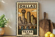 A vintage-style metal sign with the text "DALLAS TEXAS USA" and an illustration of a city skyline with a bridge.