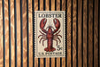 A U.S. postage stamp featuring a lobster illustration.