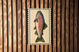 a colorful fish illustration on a wooden background.