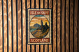 A vintage-style postage stamp depicting the Isle of Skye, Scotland, with mountains and a sunset in the background.