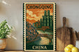 A framed vintage postage stamp depicting a cityscape with a bridge, surrounded by potted plants and kitchen utensils.