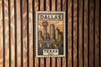 A vintage-style metal stamp depicting the skyline of Dallas, Texas, with the text "DALLAS TEXAS USA" prominently displayed.