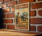 A vintage postage stamp depicting a traditional Korean temple, with the text "GYEONGJU SOUTH KOREA" printed on it, is displayed on a brick wall.