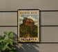 A framed poster of Sigiriya Rock, a famous landmark in Sri Lanka, is displayed on a wall.