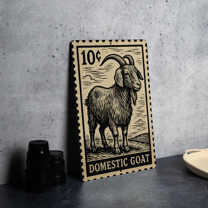 A 10-cent postage stamp featuring a domestic goat, placed on a table next to some black camera lenses.