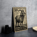 A 10-cent postage stamp featuring a domestic goat, placed on a table next to some black camera lenses.