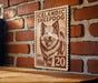 A wooden table with a wooden border, against a brick wall. There is a wooden sign with a picture of a dog and the text "Icelandic Sheepad Dog" on it.