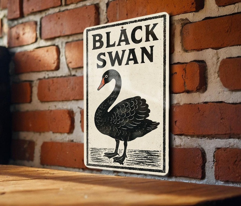 A sign featuring a black swan is mounted on a brick wall.