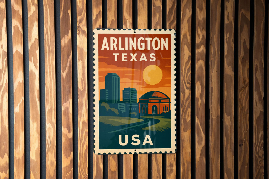 A vintage-style postage stamp from the United States, featuring the city of Arlington, Texas, with a sunset and buildings in the background.