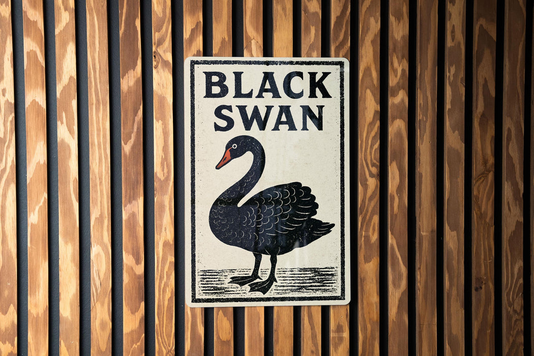 A sign with the text "BLACK SWAN" and an illustration of a black swan is displayed on a wooden wall.
