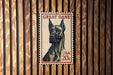 A postage stamp featuring a Great Dane dog, with the text "GREAT DANE" and "USA 20c" printed on it.