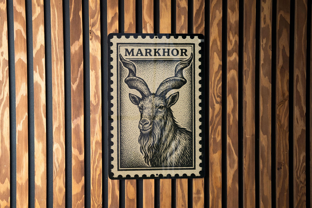 A metal stamp with a black and white illustration of a horned animal, likely a goat or ram, is mounted on a wooden wall.