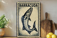 a decorative sign with a fish illustration, placed on a wooden surface next to a potted plant and a wooden cutting board.