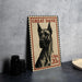 A Great Dane postage stamp is displayed on a table, with a stack of black camera lenses and a woven basket nearby.