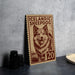A wooden postcard featuring an illustration of a sheepdog, with the text "ICELANDIC SHEEPDOG" and the number "20" printed on it.
