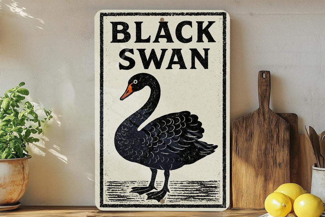 a sign with a black swan illustration, placed on a wooden surface next to a wooden cutting board and some lemons.