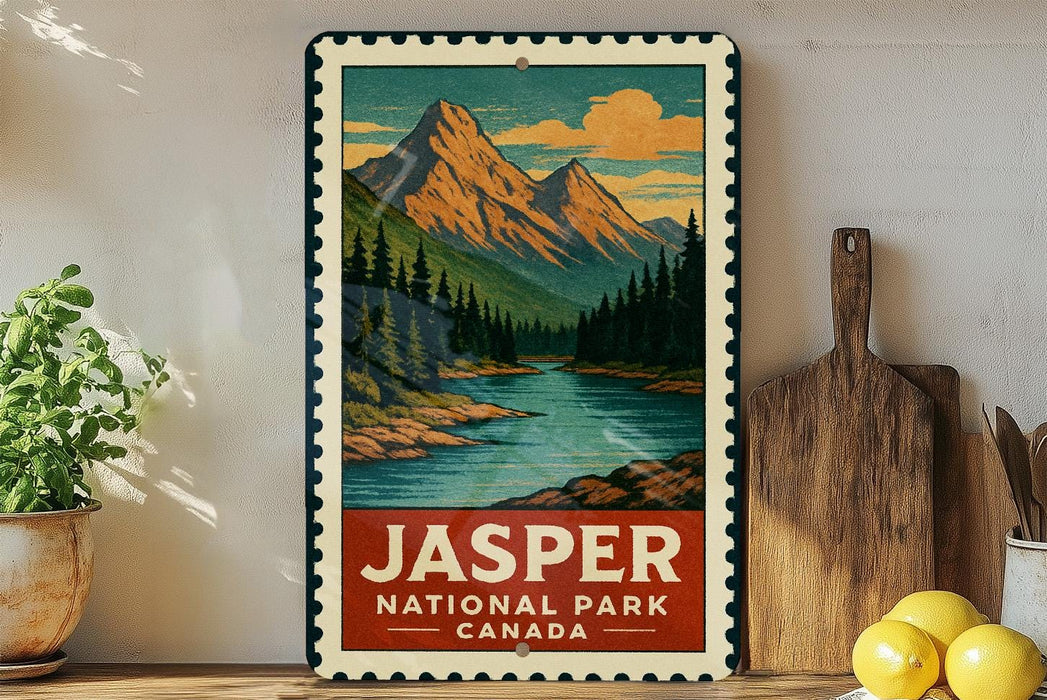 A vintage-style metal sign for Jasper National Park in Canada, featuring a mountain landscape with pine trees and a river.