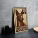 A metal stamp featuring a dog's portrait, with the text "Portuguese Podego" printed on it.