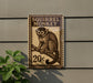 a wooden sign with a monkey illustration, mounted on a wall.