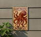 a sign with an illustration of an octopus, mounted on a wall.