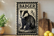 a metal sign with a black and white illustration of a badger, placed on a wooden surface next to a wooden cutting board and some lemons.