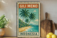 A vintage-style metal sign with a tropical beach scene and palm trees, featuring the text "Gili Meno Indonesia" on it. The sign is displayed on a shelf next to a wooden cutting board and a potted plant.