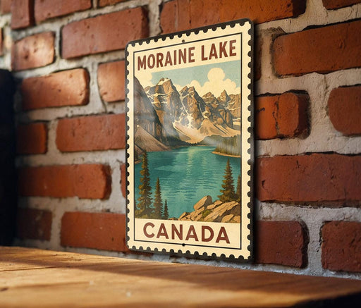 A vintage-style metal sign with a mountain landscape and a lake, mounted on a brick wall.
