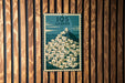 A vintage-style poster of Greek islands is displayed on a wooden wall.