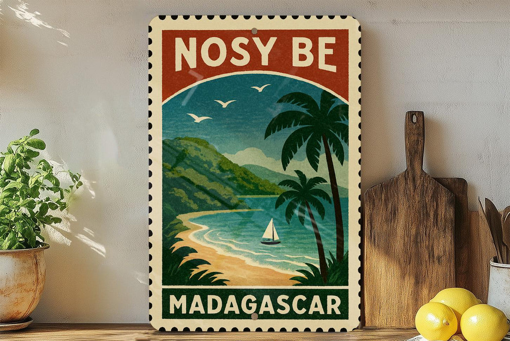 A vintage-style stamp depicting a tropical beach scene with palm trees, a sailboat, and mountains in the background, along with the text "NOSY BE MADGASCAR".