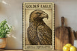 a framed illustration of a golden eagle, with the text "GOLDEN EAGLE" and "AQUILA CHRYSAETOS" printed on it. The framed image is displayed on a shelf next to a wooden cutting board and a potted plant.