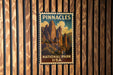 A vintage-style poster of Pinnacles National Park in the USA, featuring a scenic mountain landscape.