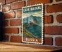 A vintage-style poster of Lake Baikal, the world's largest lake, is displayed on a brick wall.