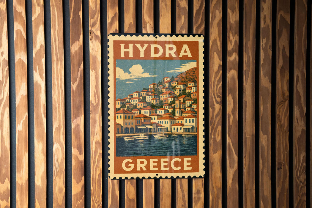 A vintage-style poster of a Greek town is displayed on a wooden wall.