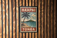 A vintage-style poster of Ha'apai, Tonga, hanging on a wooden wall.