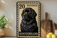 A metal sign with a black and white illustration of a dog, resembling a postage stamp, is displayed on a shelf next to a wooden cutting board and some lemons.