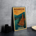 A vintage-style metal sign with a colorful illustration of a temple and a bridge, along with the text "RISHIKESH INDIA" on it, is displayed on a gray wall.