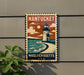 A vintage-style metal sign with a lighthouse and ocean scene, mounted on a wall.