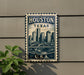 A metal sign with the text "HOUSTON TEXAS U.S.A." and an illustration of a city skyline, mounted on a wall.