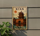 A decorative sign featuring a traditional Chinese temple, with the text "XI'AN CHINA" prominently displayed.