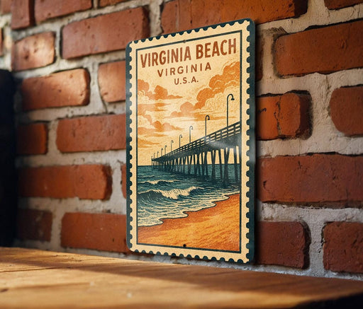 A vintage-style poster of a pier and beach scene is displayed on a brick wall, with a wooden table below it.