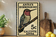 A framed print of a hummingbird, with text indicating it is a postage stamp for Anna's hummingbird.