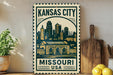 A decorative metal sign with the text "KANSAS CITY MISSOURI USA" and an illustration of a city skyline.
