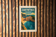 A vintage-style poster of Zakynthos, Greece, displayed on a wooden wall.
