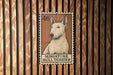 a miniature bull terrier dog, which is depicted in a stamp-like format.